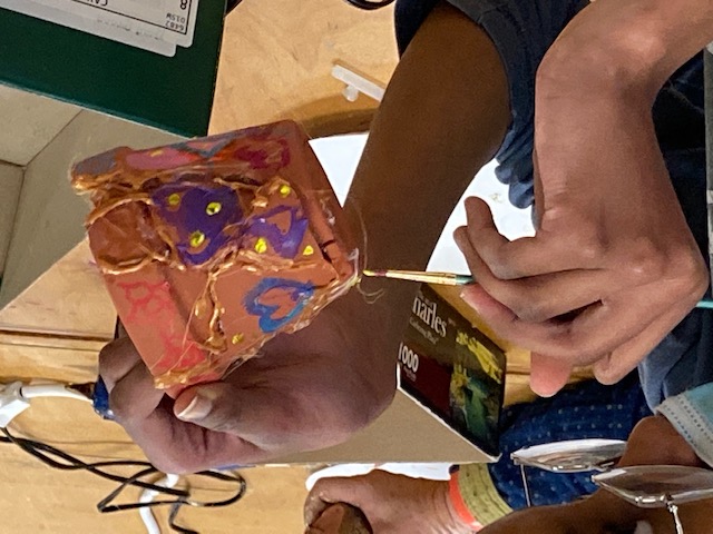 a kintsugi pot in the process of being painted