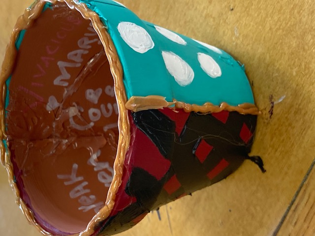 a kintsugi pot decorated with two different patterns, symbolizing duality