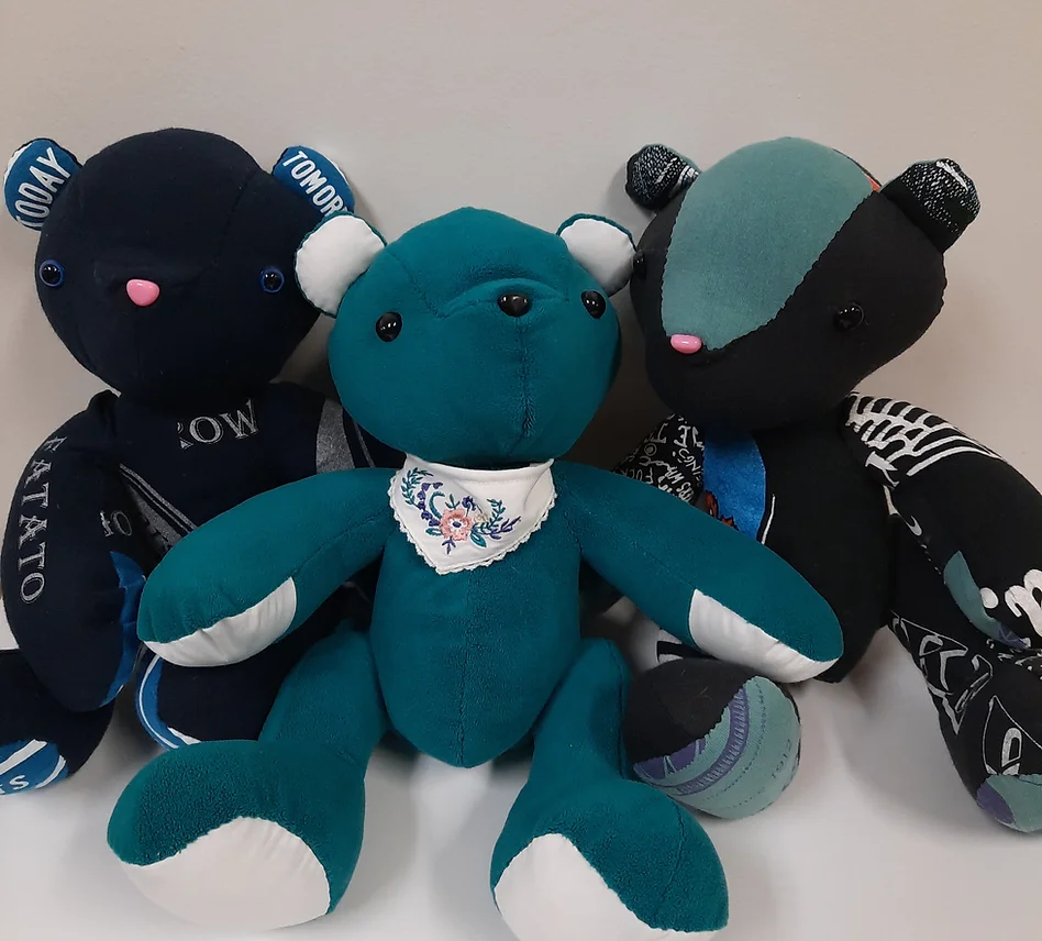 a small stuffed bear made of fabric from clothing worn by a loved one that's passed away